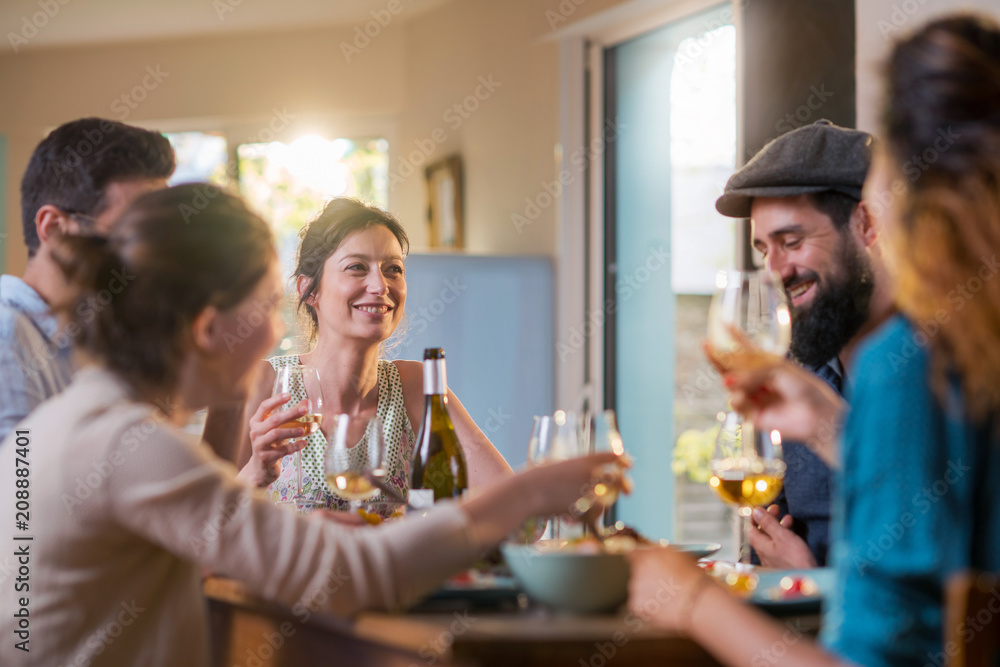 Mixed group of friends having fun while sharing a meal Mixed group of friends having fun while sharing a meal