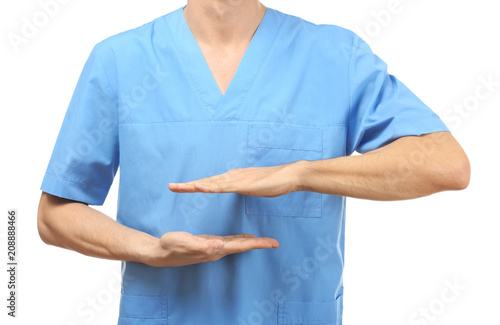 Male doctor holding something on white background