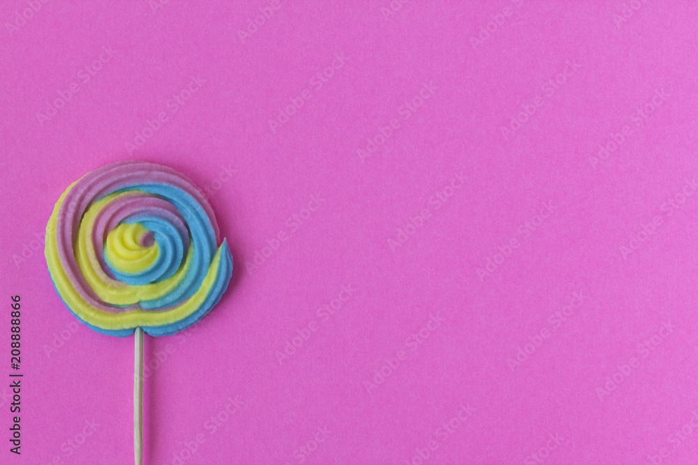Creative view of colorful, handmade swirl lollipop in summer colors on pink paper background. Minimalism. Abstraction. Creativity. Creative view of colorful, handmade swirl lollipop in summer colors on pink paper background. Minimalism. Abstraction. Creativity.