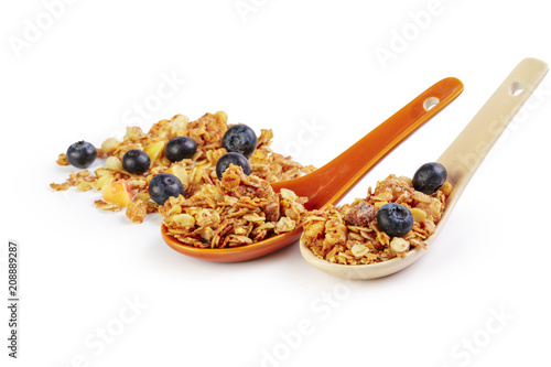 Granola spoon with billberry isolated on white background