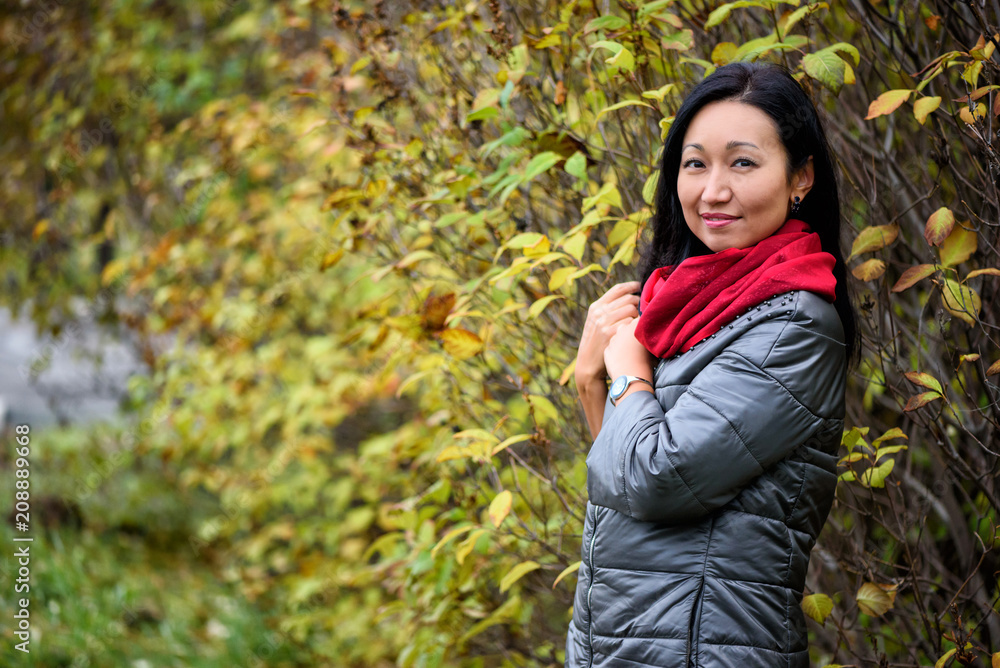 Fall woman smiling - Autumn portrait of happy lovely and beautiful mixed race Asian Caucasian young woman in forest in fall colors. Fall woman smiling - Autumn portrait of happy lovely and beautiful mixed race Asian Caucasian young woman in forest in fall colors.