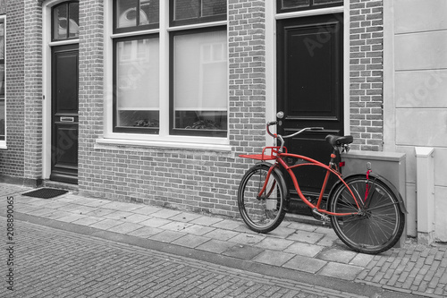 Red bicycle in an old street in a city in the Netherlands Europe