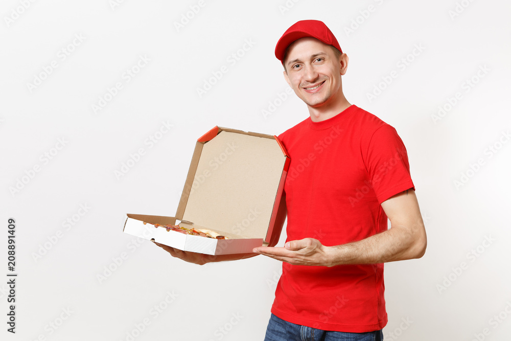 Delivery smiling man in red uniform isolated on white background. Male pizzaman in cap, t-shirt working as courier or dealer holding italian pizza in cardboard flatbox. Copy space for advertisement. Delivery smiling man in red uniform isolated on white background. Male pizzaman in cap, t-shirt working as courier or dealer holding italian pizza in cardboard flatbox. Copy space for advertisement.