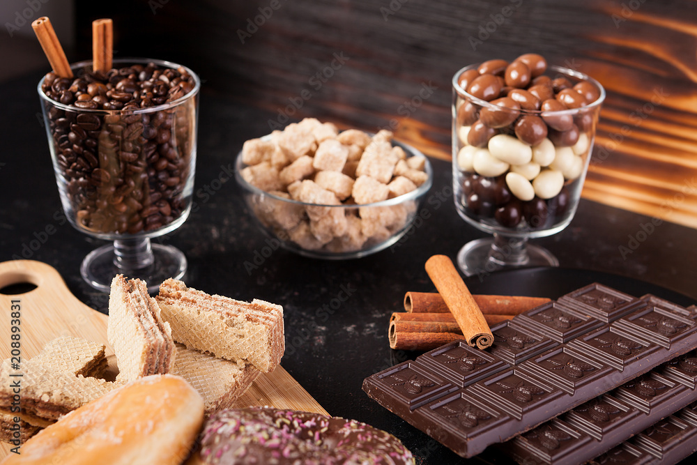 Unhealthy but delicous sweets and pastry on dark wooden background in studio photo