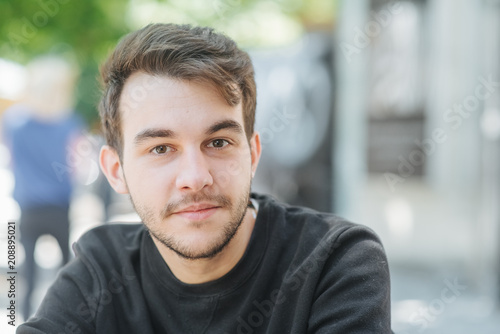 Bild auf Leinwand Story of the day. Front view of pensive young man outdoor.
