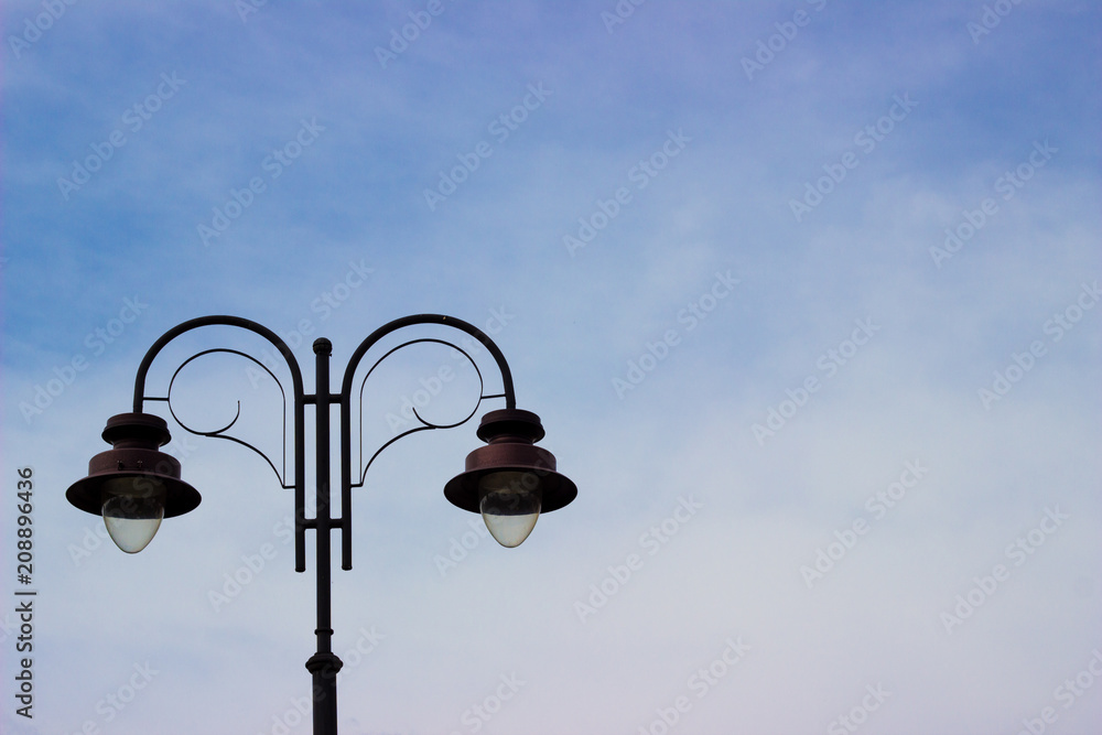 Street light. Old Metal Lamp. Blue sky. Empty space for text and design. Street light. Old Metal Lamp. Blue sky. Empty space for text and design.