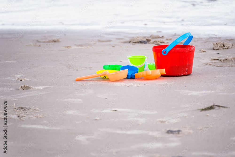 Children's beach toys - buckets, spade and shovel on sand on a sunny day. Children's beach toys - buckets, spade and shovel on sand on a sunny day.