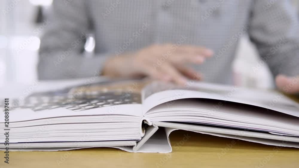 Male hand opening book pointing finger on page. Young university student man doing self-study for educational research in college library. Education lifestyle concept. 4K video Male hand opening book pointing finger on page. Young university student man doing self-study for educational research in college library. Education lifestyle concept. 4K video