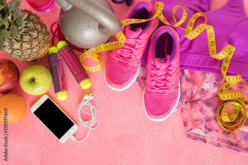 Different fitness objects on pink surface © Kaspars Grinvalds