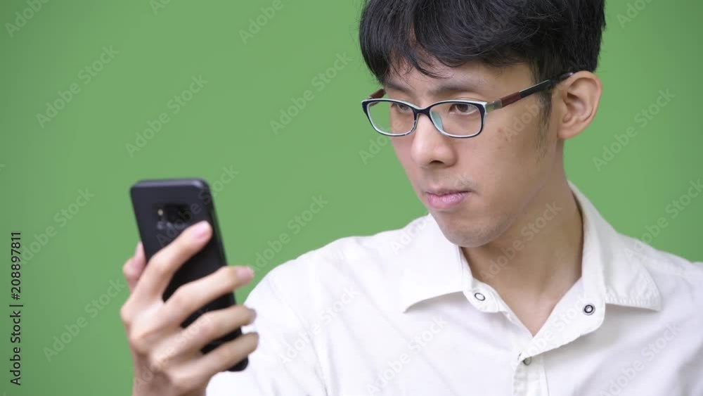 Young Asian businessman using phone Young Asian businessman using phone