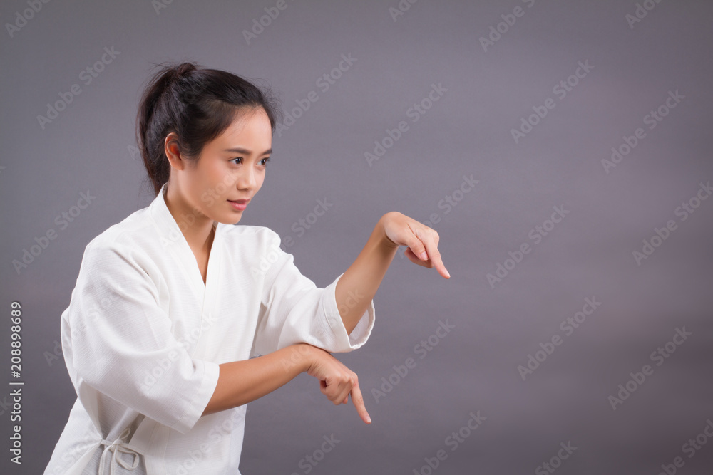 woman fighter portrait; asian woman practicing chinese martial arts, gongfu, kungfu, taichi, taiji, MMA studio isolated portrait; girl fighter training concept; 20s young adult asian woman model woman fighter portrait; asian woman practicing chinese martial arts, gongfu, kungfu, taichi, taiji, MMA studio isolated portrait; girl fighter training concept; 20s young adult asian woman model
