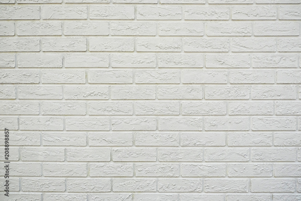 White brick wall. Stone wall texture. Decorative tile. Textured background. The white surface of the brick. White brick wall. Stone wall texture. Decorative tile. Textured background. The white surface of the brick.