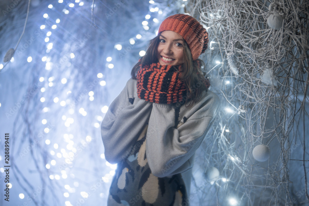 Girl with a smile in with a scarf and hat in winter location Girl with a smile in with a scarf and hat in winter location