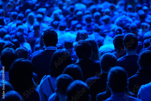 Audience listens to the lecturer at the conference hall © Anton Gvozdikov