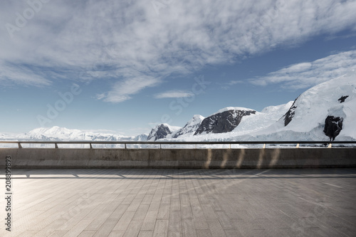 empty brick ground with sonw mountain as background photo