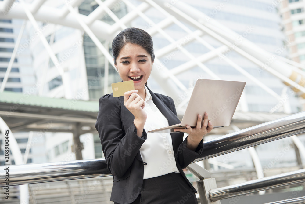 businesswoman using computer and credit card for internet banking. e-commerce internet technology concept. businesswoman using computer and credit card for internet banking. e-commerce internet technology concept.