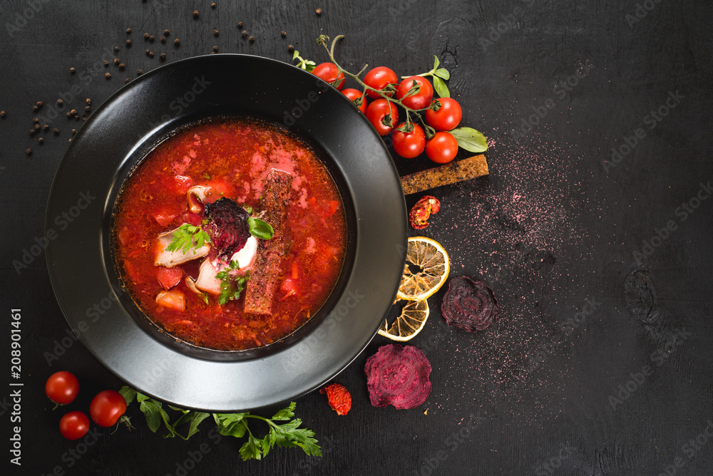 Red soup ukrainian borsch on black background. Top view