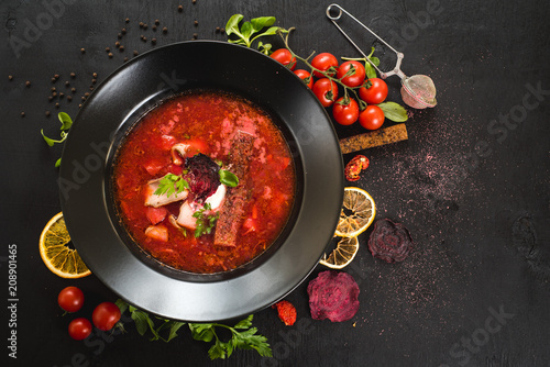 Red soup ukrainian borsch on black background. Top view