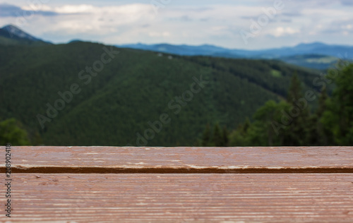 soft focus wooden table surface and mountain nature unfocused background landscape concept with empty space for copy or text