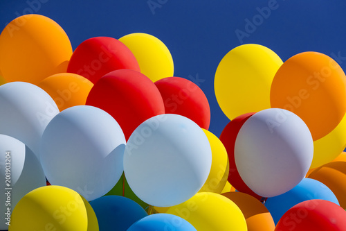 Background of a set of colored balloons on the sky background 