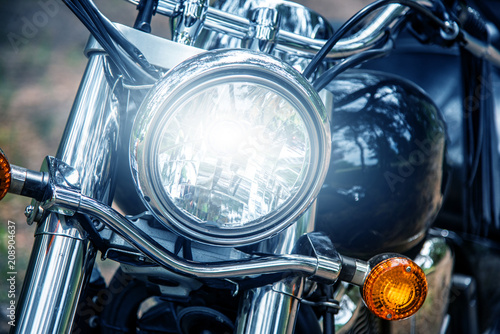 Motorcycle headlight close up, film blue tone style