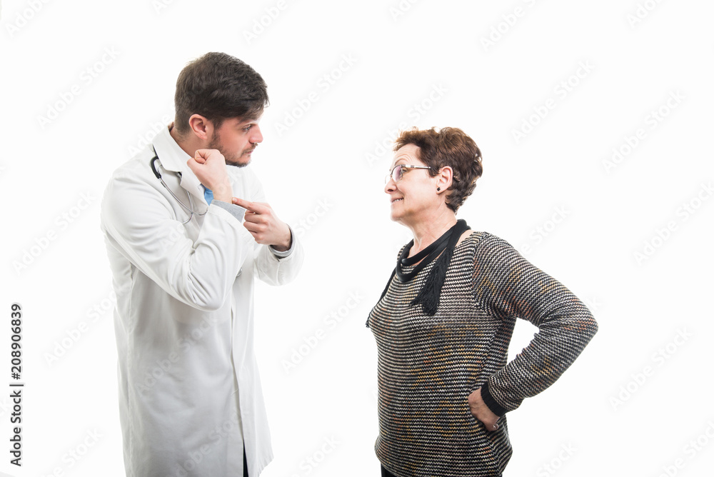 Male doctor showing late gesture to female senior patient Male doctor showing late gesture to female senior patient