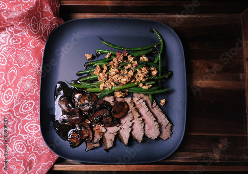 sliced rare steak and green bean salad photo