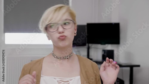 Crazy funny young office woman making childish grimaces crossing eyes pulling tongue out playing fool