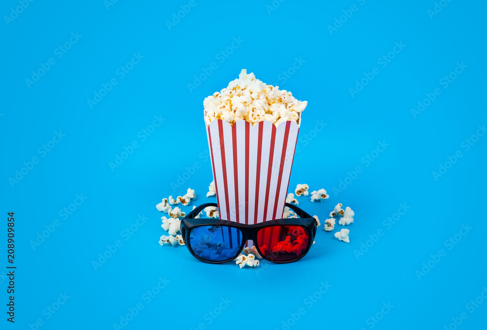 Popcorn and 3d glasses on blue background