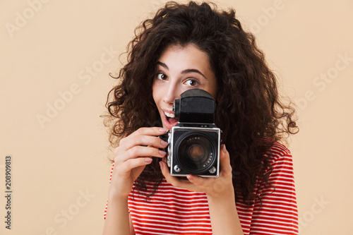 Pretty young curly woman photographer