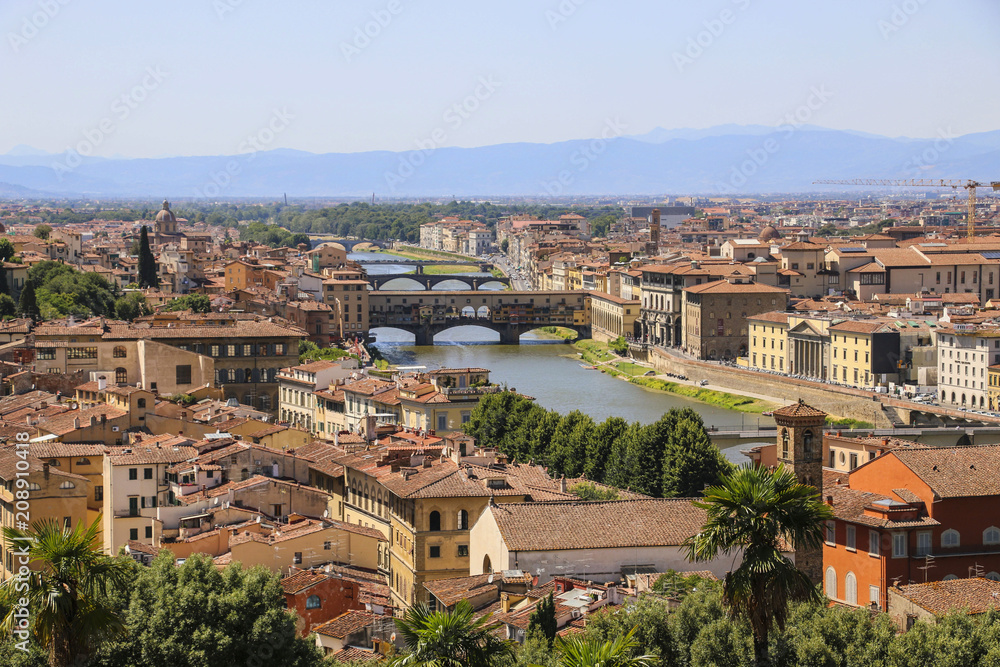 View of the roofs of houses of Florence, the Arno River and bridges, Italy