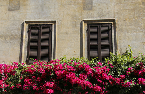 Traditional Italian windows with shutters in one of the houses of Rome, Italy