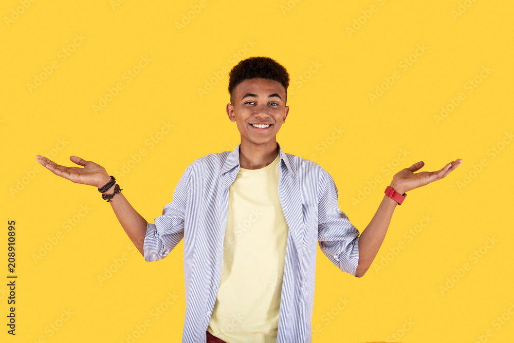 Facial expression. Happy cheerful man smiling while looking at you Facial expression. Happy cheerful man smiling while looking at you