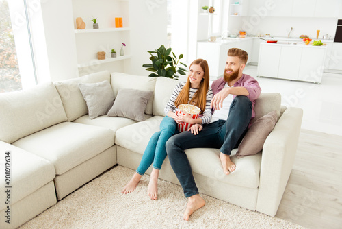 Day freetime chill two partners people ginger hair vacation concept. Cute sweet careless handsome beautiful excited cheerful lovers eating pop corn from basket watching favorite film in living room