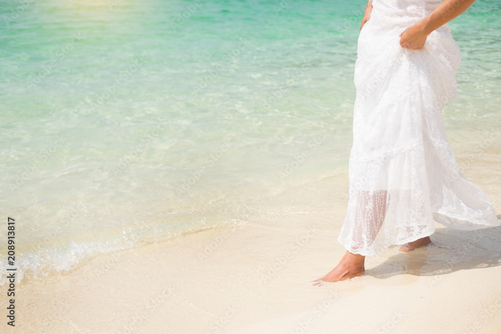 a beautiful carefree Woman relaxing at the beach enjoying her sun dress freedom wear. a beautiful carefree Woman relaxing at the beach enjoying her sun dress freedom wear.