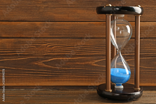 Hourglass on wooden background. Time management concept