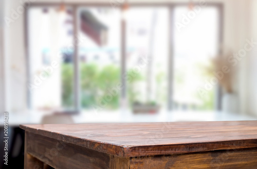 Selected focus empty brown wooden table and Coffee shop blur background with bokeh image. for your photomontage or product display