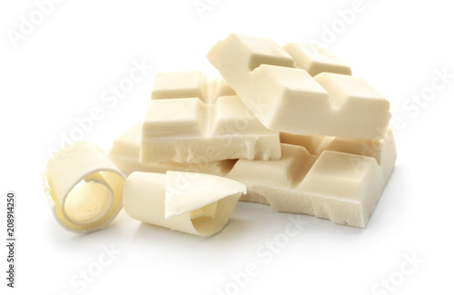 Pieces of chocolate and curls on white background