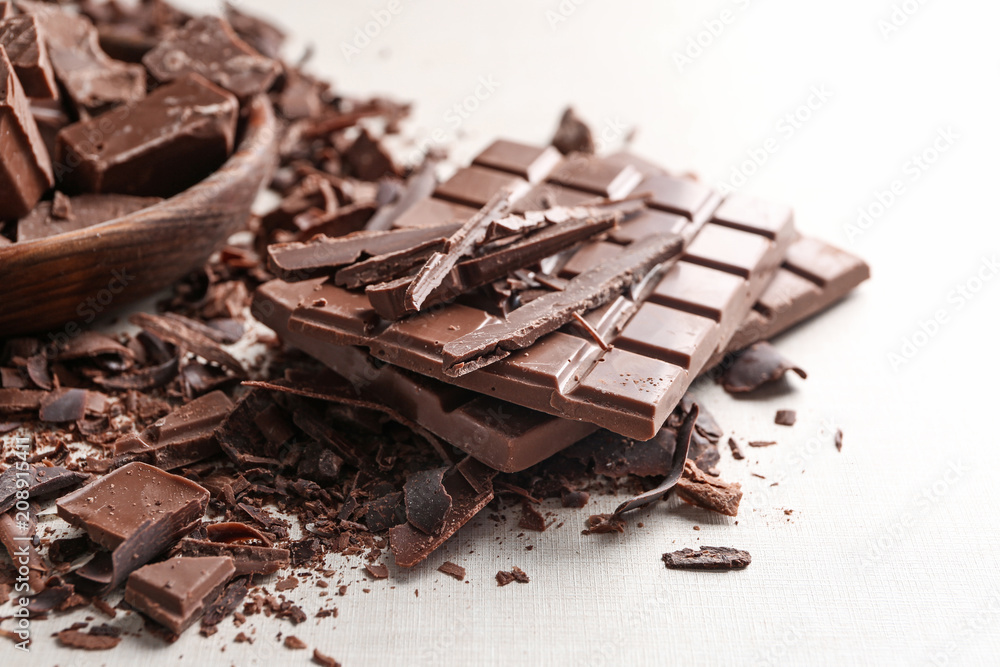 Fototapeta premium Pieces and bars of chocolate on table