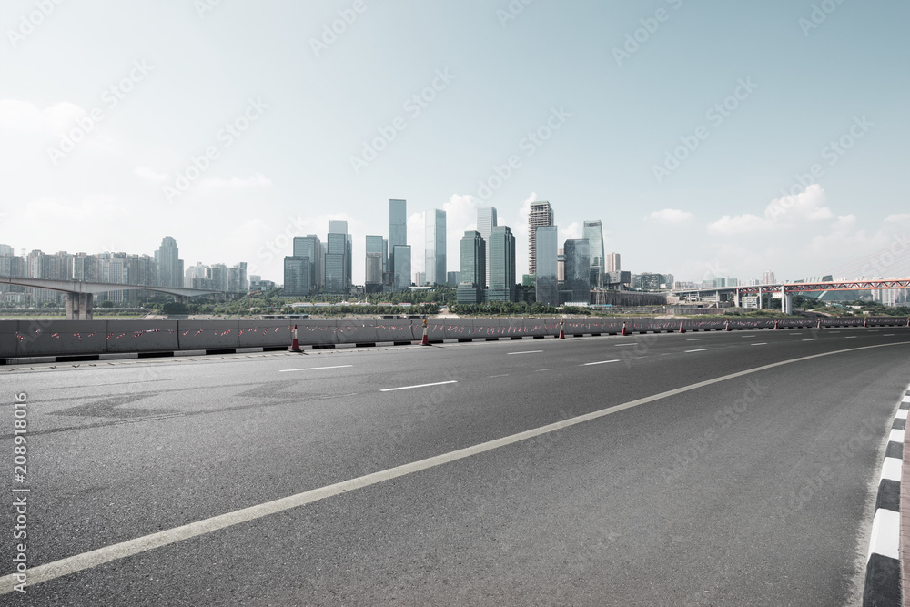 empty asphalt road with modern city skyline