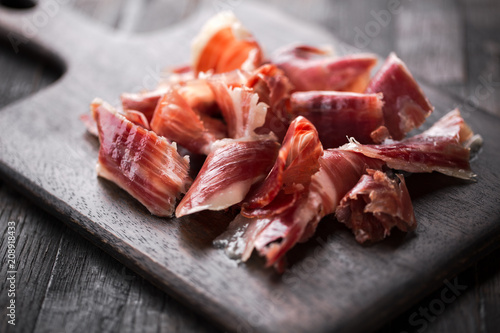 Traditional Spanish Jamon Serrano ham, Prosciutto Crudo, Parma ham, Italian antipasto. photo