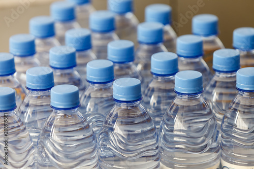 the texture of the necks of plastic bottles of water closeup photo