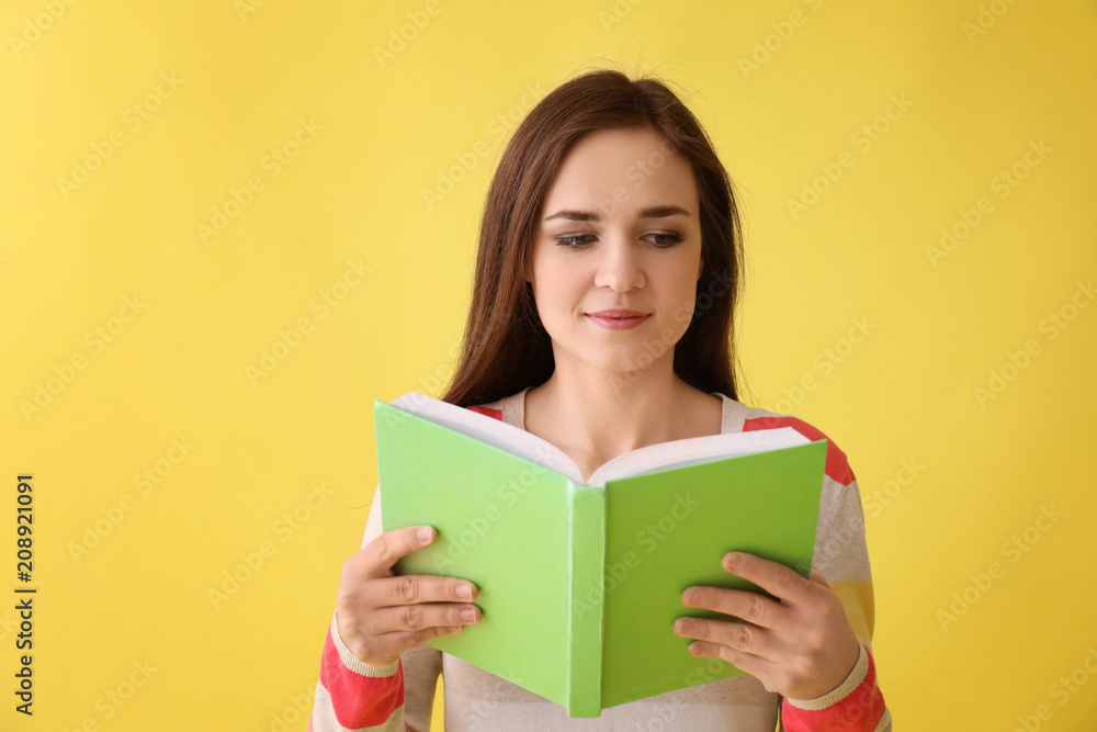 Young woman with book on color background Young woman with book on color background
