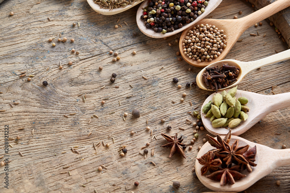 Spoons with aromatic various spices for cooking on old wooden board, close-up, flat lay, selective focus. Spoons with aromatic various spices for cooking on old wooden board, close-up, flat lay, selective focus.