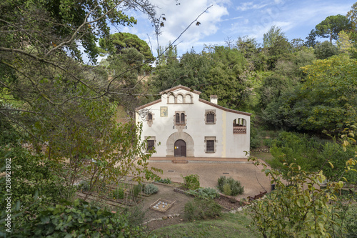 Traditional catalan rural house, Masia, in old botanical garden, Jardi Botanic Historic, Parc de Montjuic, Barcelona. photo