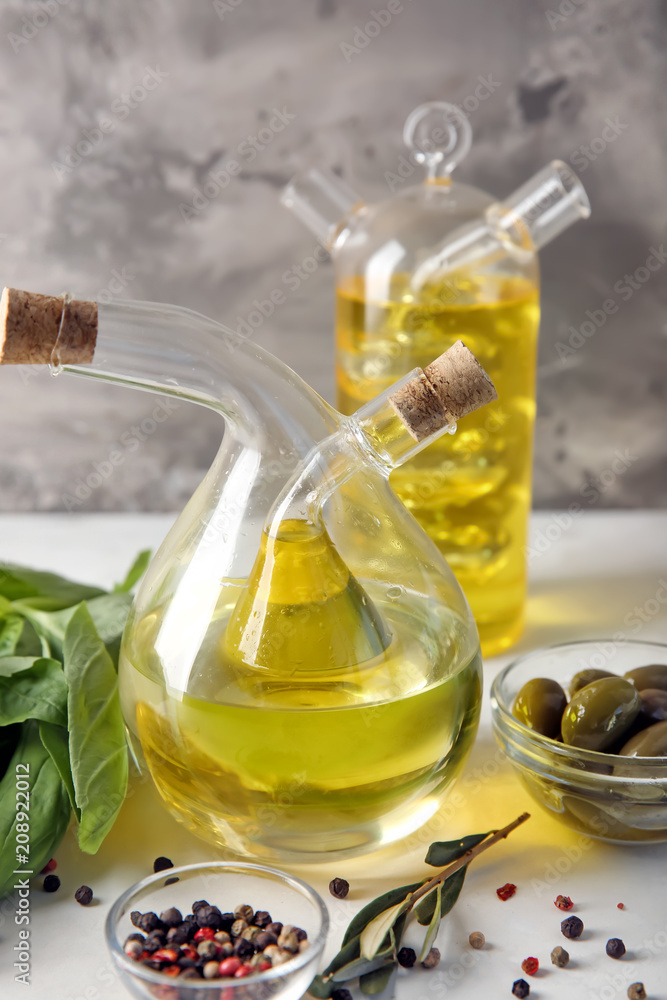 Bottles with oil and olives on table Bottles with oil and olives on table