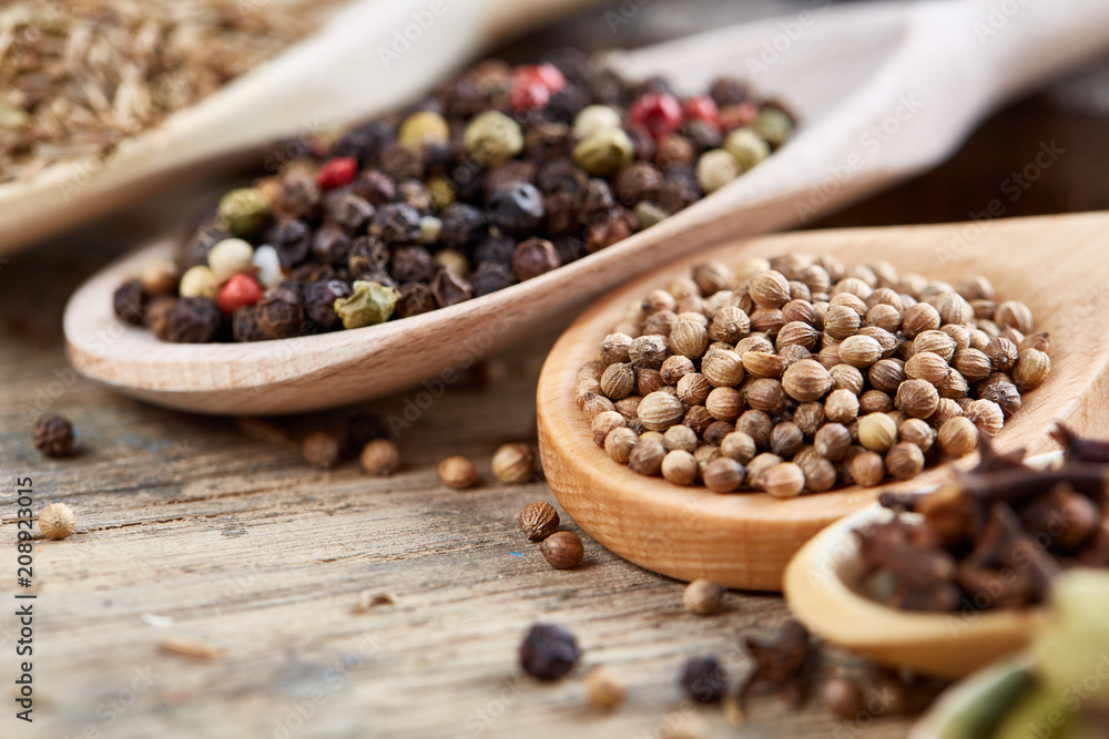 Colourful aromatic various spices for cooking on old wooden board, close-up, flat lay, shallow depth of field. Colourful aromatic various spices for cooking on old wooden board, close-up, flat lay, shallow depth of field.