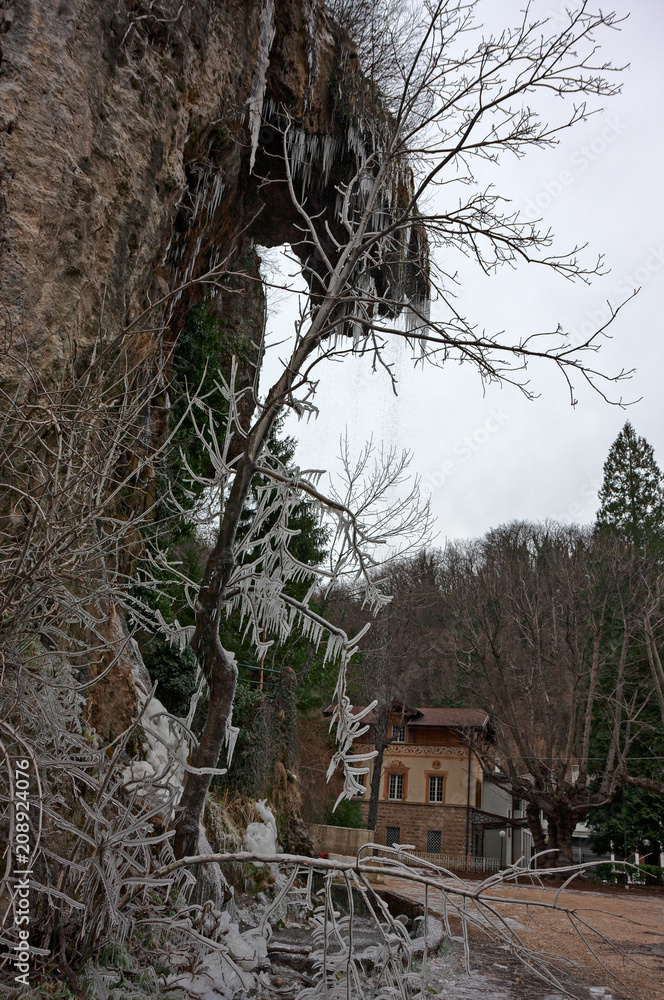 View of rocks and branches covered with ice on a cold winter day. View of rocks and branches covered with ice on a cold winter day.