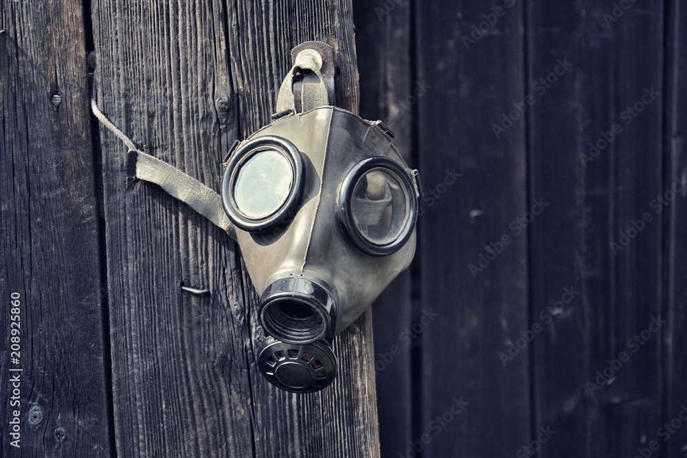 Old gas mask wooden background, terrorism pollution concept Stock | Stock