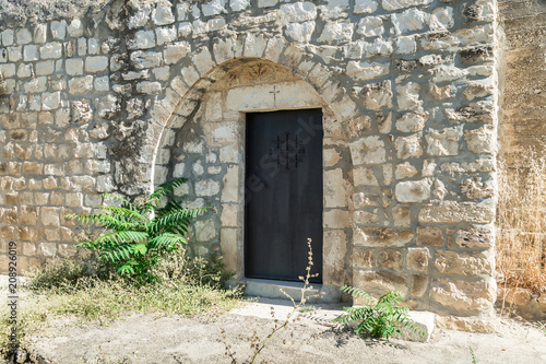 Side door in the functioning church of the Christian Maronites in the abandoned village Kafr Birim in the north of Israel photo